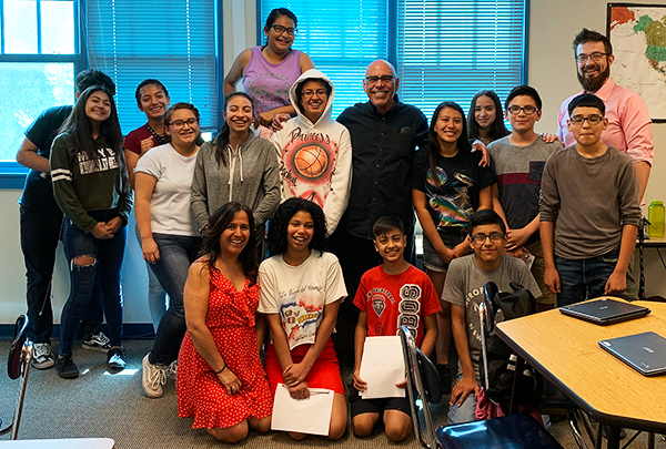 Group of smiling students and teacher